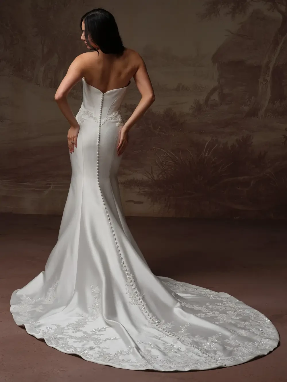 model is wearing a strapless fit and flare bridal gown