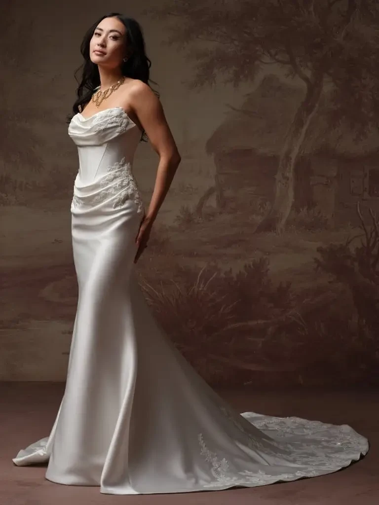 model is wearing a strapless fit and flare bridal gown