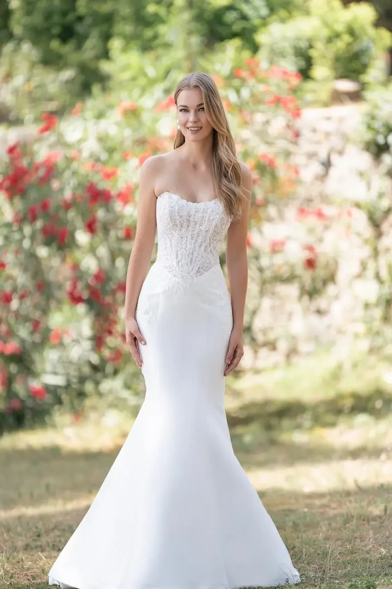model is wearing a strapless fit and flare wedding dress